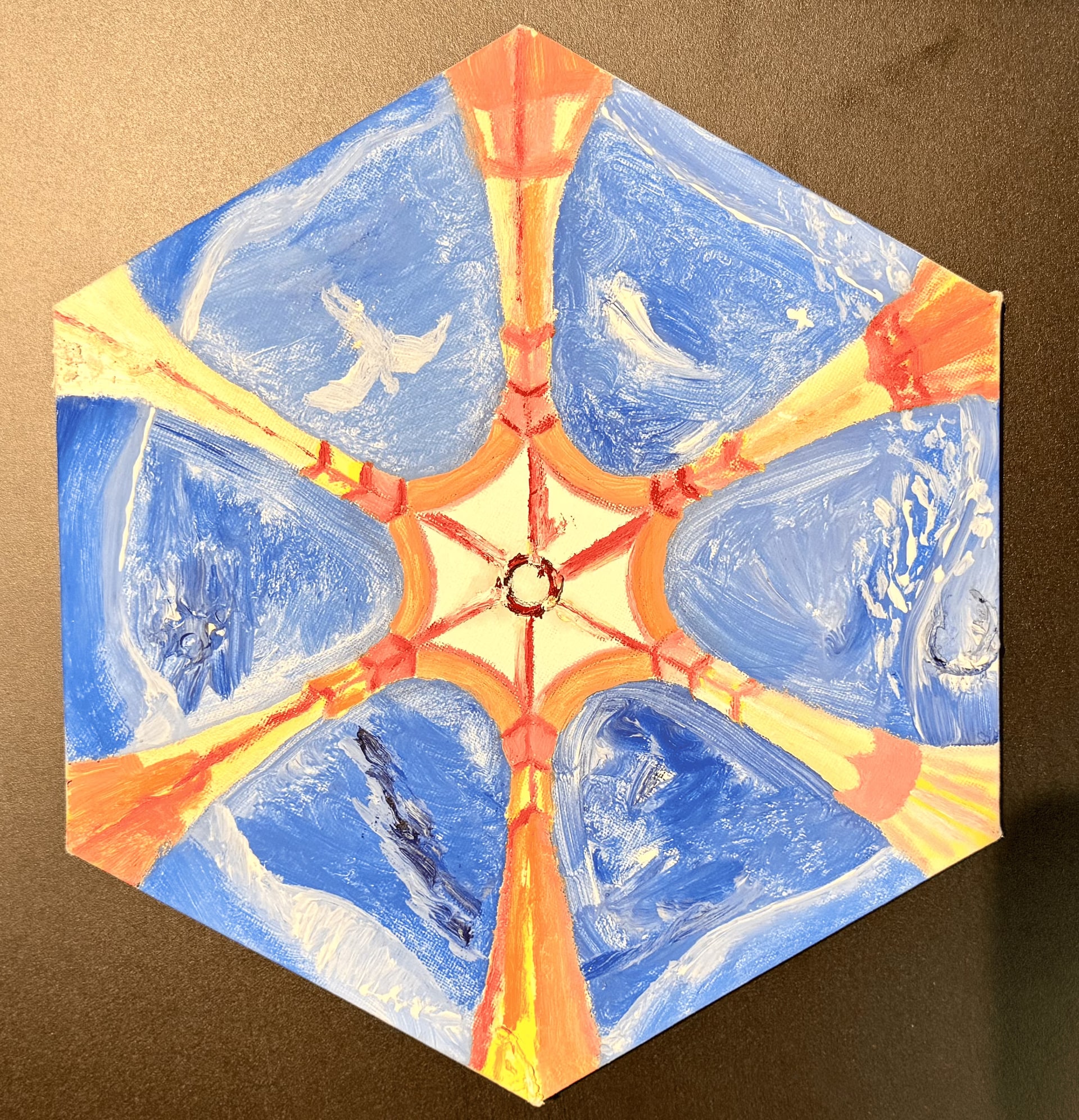 A hexagonal canvas resting on a brown surface, painted as the view up into a six-part vault. Six panels of blue sky sit between orange and red ribs that converge on a small dark ring at the pale centre, and a white bird flies through one of them.